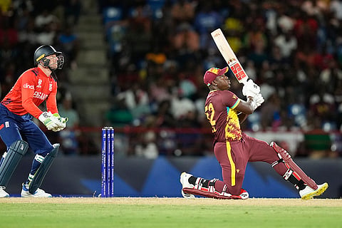 Rovman Powell hits the ball for six against England